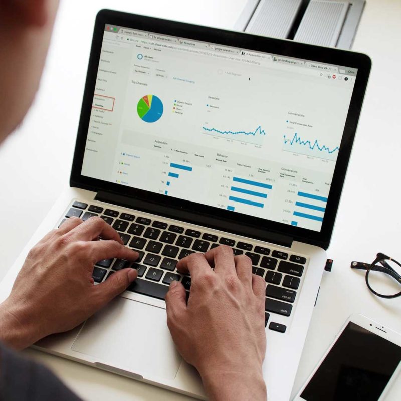 Guy on laptop looking at financial information