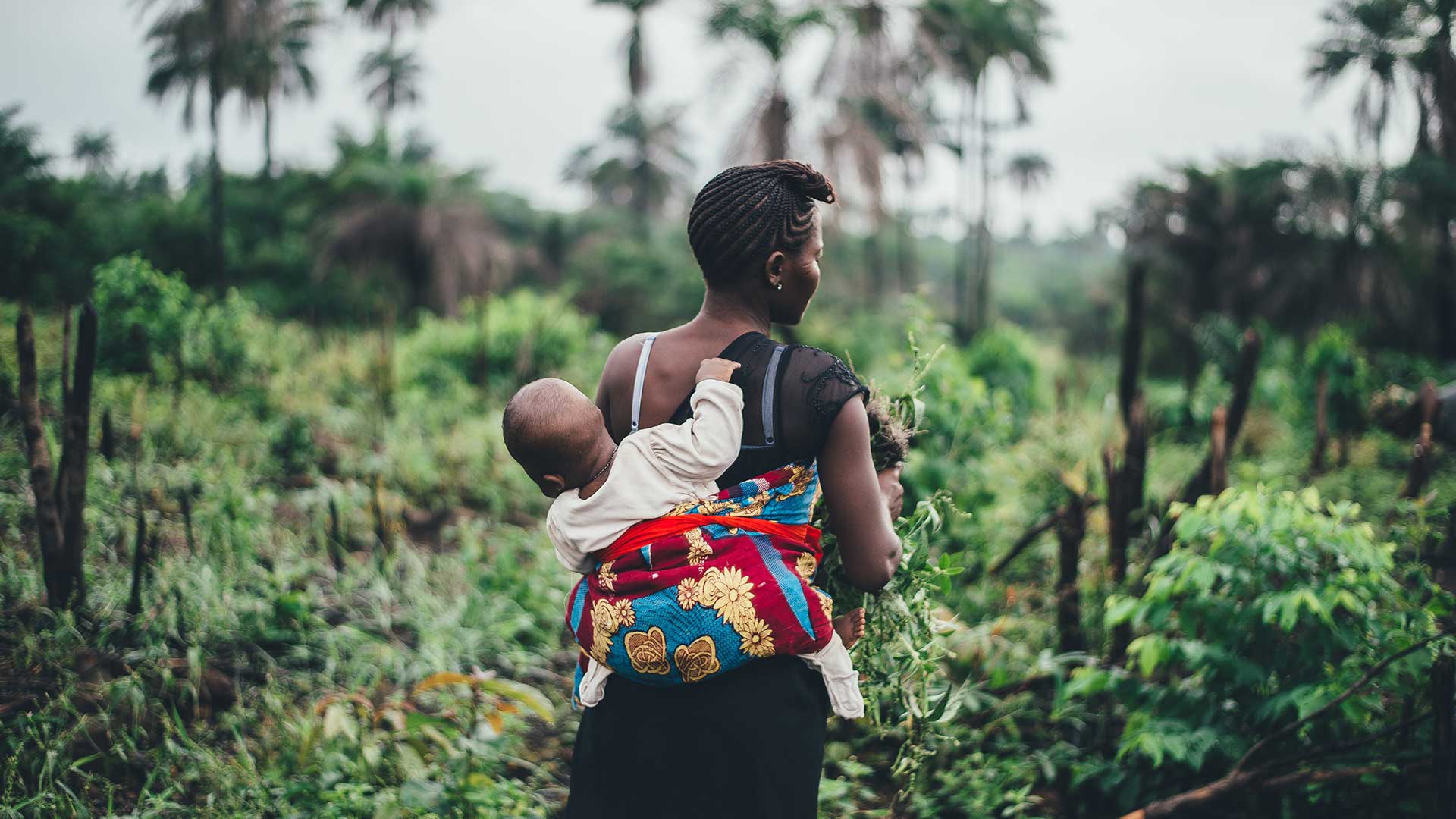 Zika Women Carrying Baby in Field