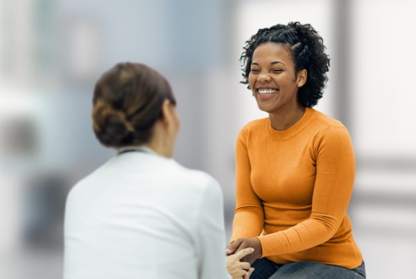 Smiling woman patient with healthcare worker
