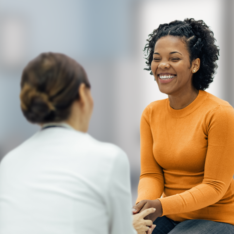 Smiling woman patient with healthcare worker